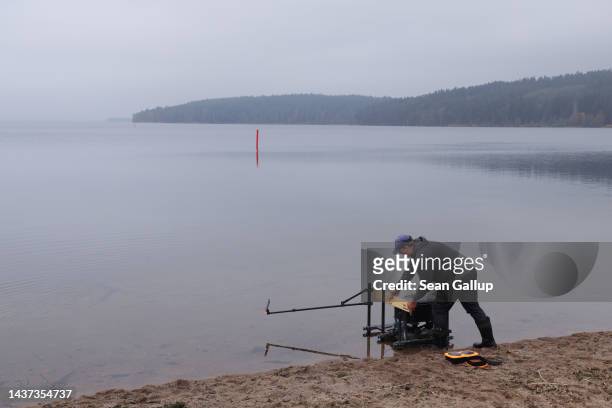 Local champion fisherman Vilius Mickevicius prepares for nighttime fishing for bream at Lake Vistytis, through which runs the border to the Russian...