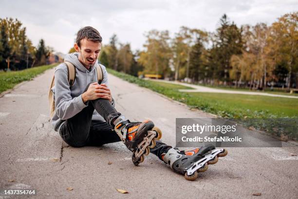 this hurts so much - inline skating man park stock pictures, royalty-free photos & images