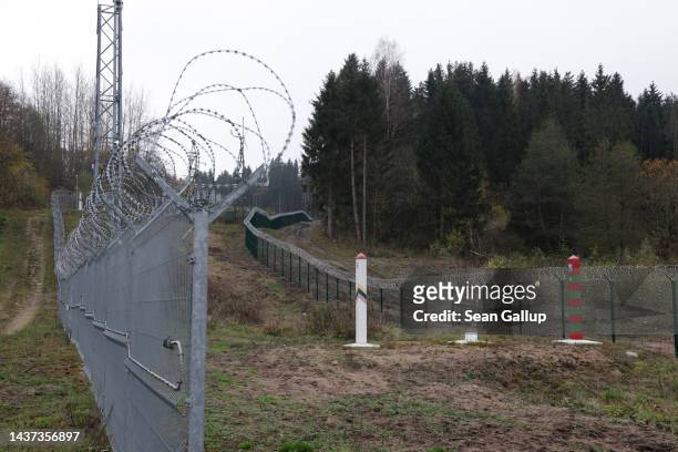 Lithuanian border fence and marker face a Russian border marker and fence along the border to the Russian semi-exclave of Kaliningrad on October 28,...