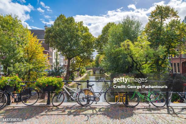 bicycles on a bridge in utrecht, holland - utrecht stock-fotos und bilder