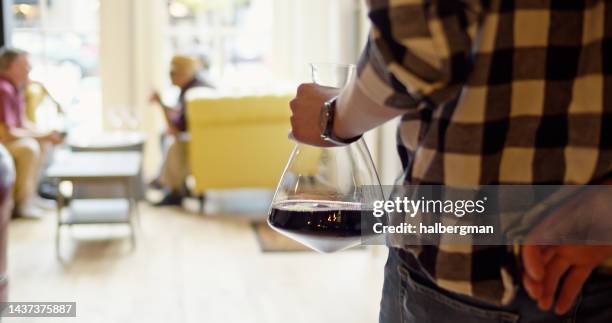 sommelier carrying decanter of wine to table in tasting room - carafe stock pictures, royalty-free photos & images