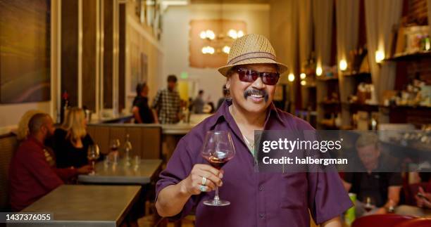 candid portrait of smiling man holding glass of red wine - handlebar moustache stock pictures, royalty-free photos & images