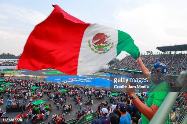 Fan with a mask waves a flag of Mexico during practice ahead of the F1 Grand Prix of Mexico at Autodromo Hermanos Rodriguez on October 28, 2022 in...