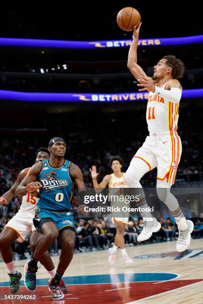 Trae Young of the Atlanta Hawks shoots on Jalen Duren of the Detroit Pistons in the first half at Little Caesars Arena on October 28, 2022 in...