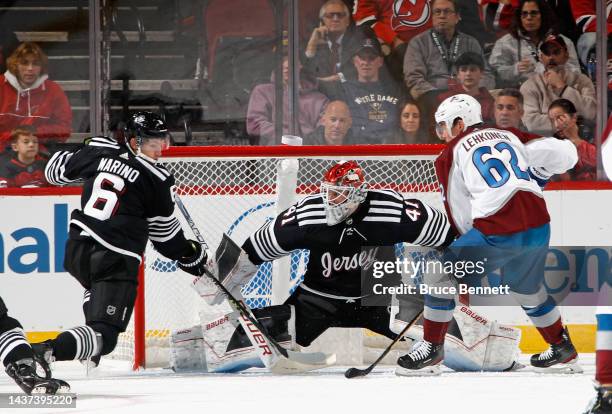 John Marino and Vitek Vanecek of the New Jersey Devils defend against Artturi Lehkonen of the Colorado Avalanche during the second period at the...