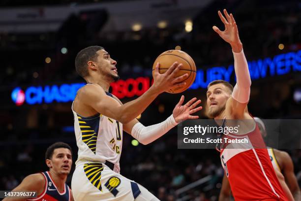 Tyrese Haliburton of the Indiana Pacers goes to the basket against Kristaps Porzingis of the Washington Wizards during the first half at Capital One...