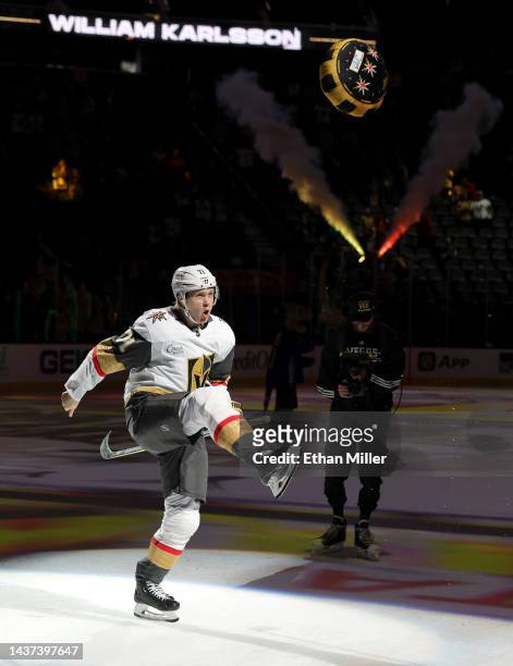 William Karlsson of the Vegas Golden Knights kicks a poker chip-themed pillow to fans after being named the second star of the game following the...