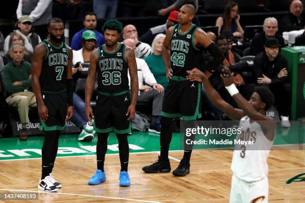 Jaylen Brown, Marcus Smart and Al Horford of the Boston Celtics watch Caris LeVert of the Cleveland Cavaliers make a free throw during overtime at TD...