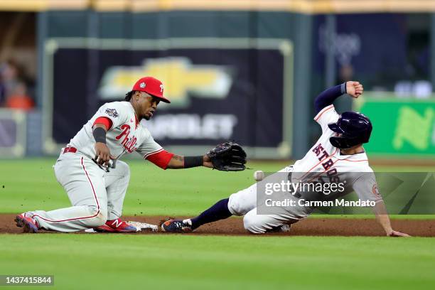 Jose Altuve of the Houston Astros steals second base past Jean Segura of the Philadelphia Phillies in the ninth inning in Game One of the 2022 World...