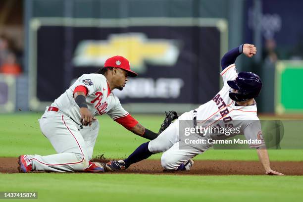 Jose Altuve of the Houston Astros steals second base past Jean Segura of the Philadelphia Phillies in the ninth inning in Game One of the 2022 World...