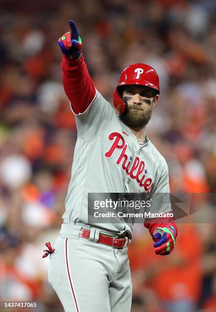 Bryce Harper of the Philadelphia Phillies celebrates after hitting a single in the 10th inning against the Houston Astros in Game One of the 2022...