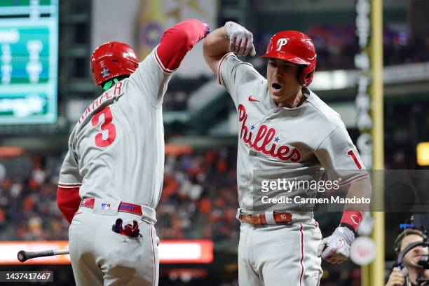 Bryce Harper and J.T. Realmuto of the Philadelphia Phillies celebrate after Realmuto hit a home run in the 10th inning against the Houston Astros in...