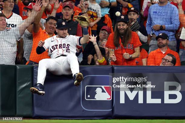 Alex Bregman of the Houston Astros reacts after failing to catch a foul ball in the 10th inning against the Philadelphia Phillies in Game One of the...