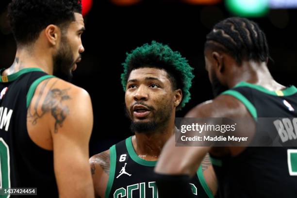 Marcus Smart of the Boston Celtics talks with Jayson Tatum and Jaylen Brown during the first half of the game against the Cleveland Cavaliers at TD...