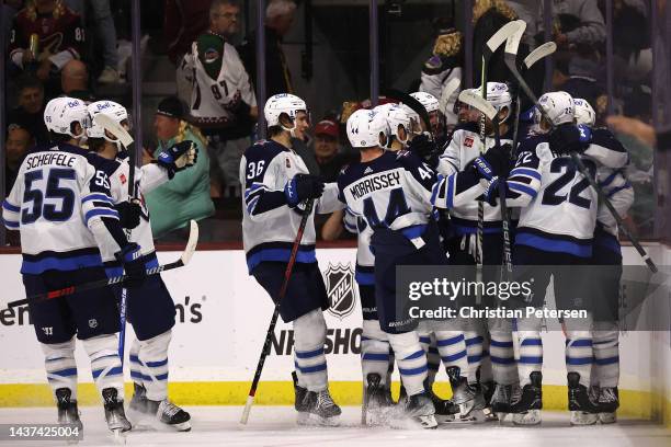 The Winnipeg Jets celebrate after Blake Wheeler scored the game-wining goal during overtime of NHL game against the Arizona Coyotes at Mullett Arena...