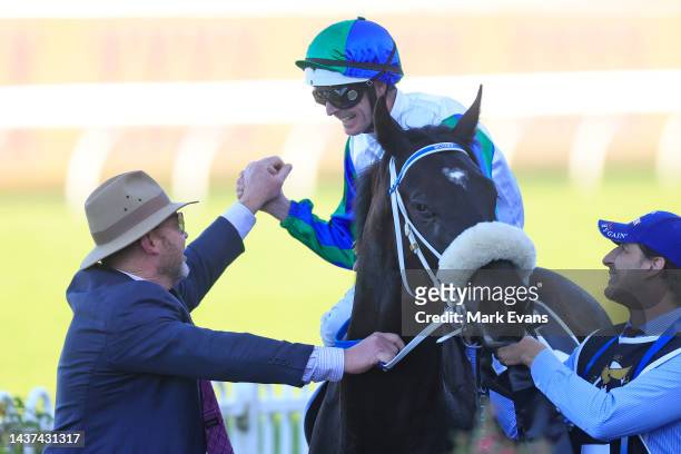 Luke Nolan on I Wish I Win greets trainer Peter Moody as he returns to scale after winning race 8 the XXXX Golden Eagle during Sydney Racing at...