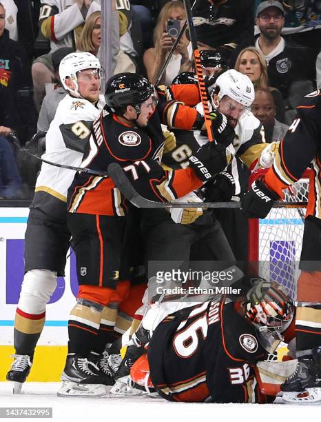 Jack Eichel of the Vegas Golden Knights moves in as his teammate Mark Stone is hit by Frank Vatrano of the Anaheim Ducks and grabbed from behind by...