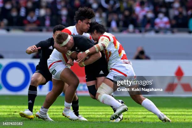 Sam Cane of New Zealand is tackled by Tevita Tatafu and Keita Inagaki of Japan during the international test match between Japan and New Zealand All...