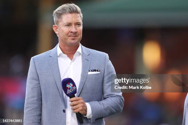 Former Australian cricketer Michael Clarke watches on as he waits to speak on camera before the ICC Men's T20 World Cup match between New Zealand and...