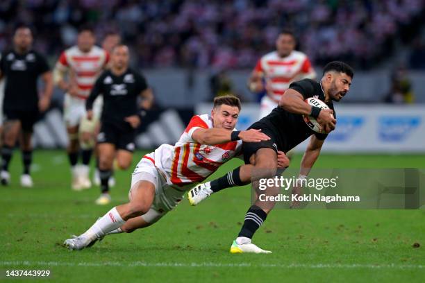 Richie Mo'unga of New Zealand is tackled by Gerhard van den Heever of Japan during the international test match between Japan and New Zealand All...