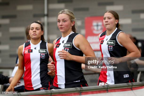 Saints run out during the round 10 AFLW match between the St Kilda Saints and the Adelaide Crows at RSEA Park on October 29, 2022 in Melbourne,...