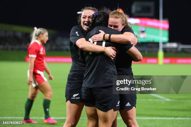 Ruahei Demant of New Zealand celebrates her try with Renee Holmes and Ariana Bayler during Rugby World Cup 2021 Quarterfinal match between New...