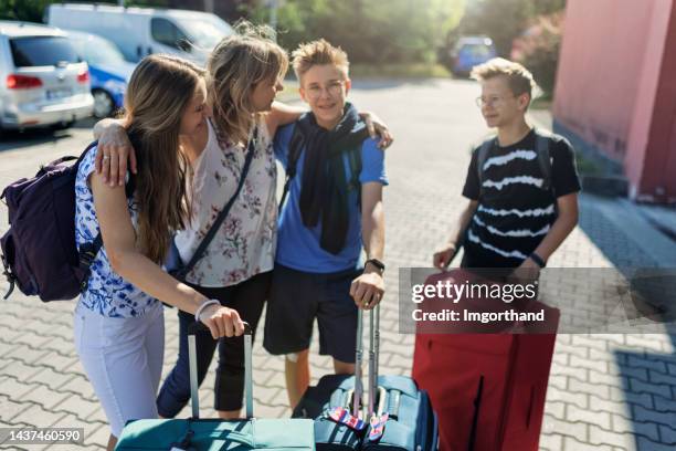 family with suitcases are waiting for the taxi. - taxi boys stock pictures, royalty-free photos & images