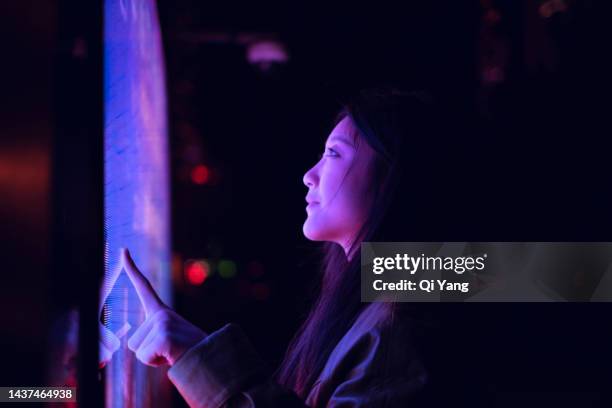 young asian woman using touch screen in financial district at night - shanghai people stock pictures, royalty-free photos & images