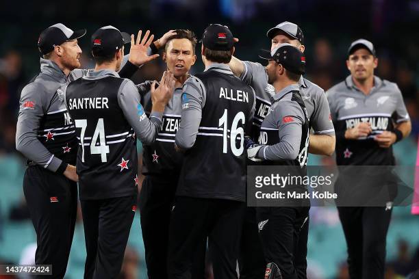 Trent Boult of New Zealand celebrates with his team after taking the wicket of Charith Asalanka of Sri Lanka during the ICC Men's T20 World Cup match...
