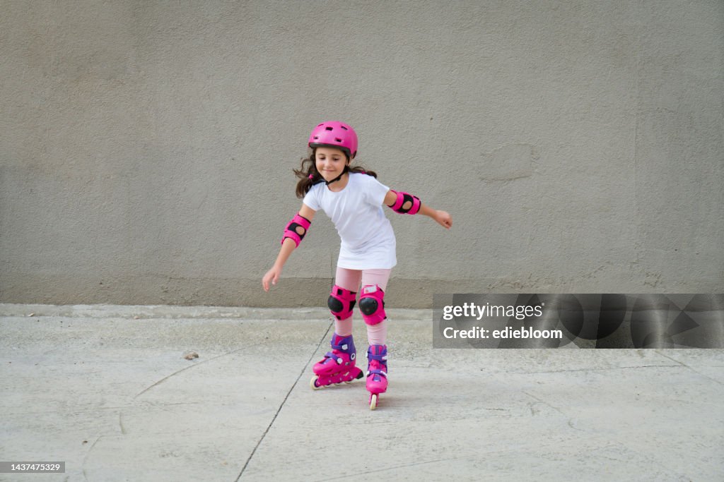 Cute little girl riding in roller skates