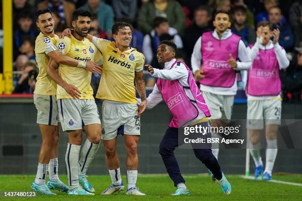 Mehdi Taremi of FC Porto celebrates with Otavio of FC Porto and Stephen Eustaqulo of FC Porto after scoring his sides fourth goal during the Group B...