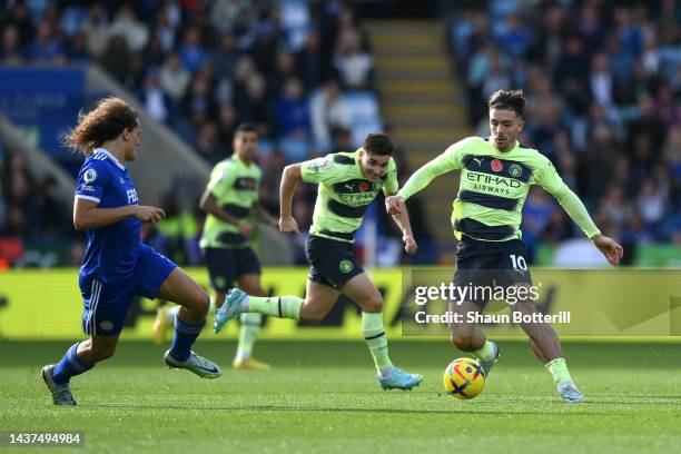 Jack Grealish of Manchester City is challenged by Caglar Soyuncu of Leicester City during the Premier League match between Leicester City and...