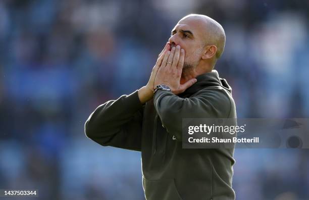 Pep Guardiola, Manager of Manchester City celebrates with the fans after their sides victory during the Premier League match between Leicester City...