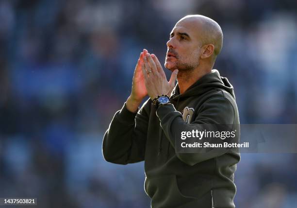 Pep Guardiola, Manager of Manchester City celebrates with the fans after their sides victory during the Premier League match between Leicester City...