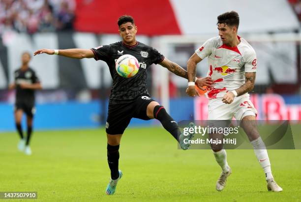 Piero Hincapie of Bayer 04 Leverkusen is challenged by Dominik Szoboszlai of RB Leipzig during the Bundesliga match between RB Leipzig and Bayer 04...