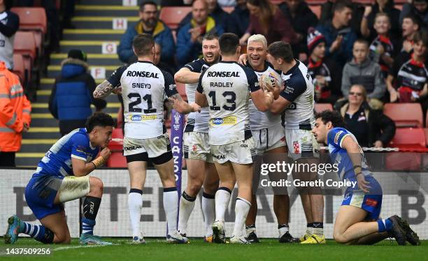 Ryan Hall of England celebrates their sides fourth try with team mates during Rugby League World Cup 2021 Pool A match between England and Greece at...