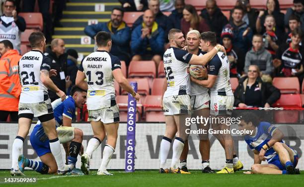 Ryan Hall of England celebrates their sides fourth try with team mates during Rugby League World Cup 2021 Pool A match between England and Greece at...