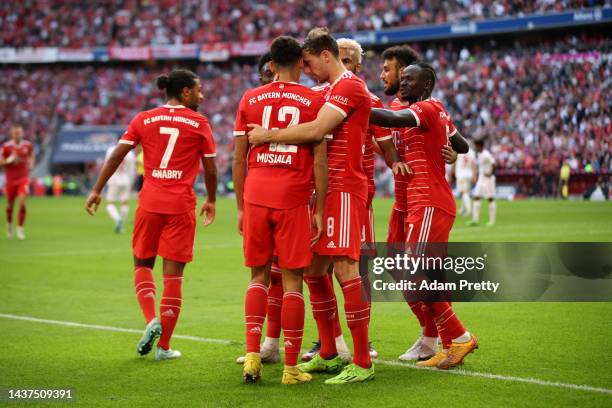 Jamal Musiala of Bayern Munich celebrates with teammates after scoring their team's second goal during the Bundesliga match between FC Bayern München...