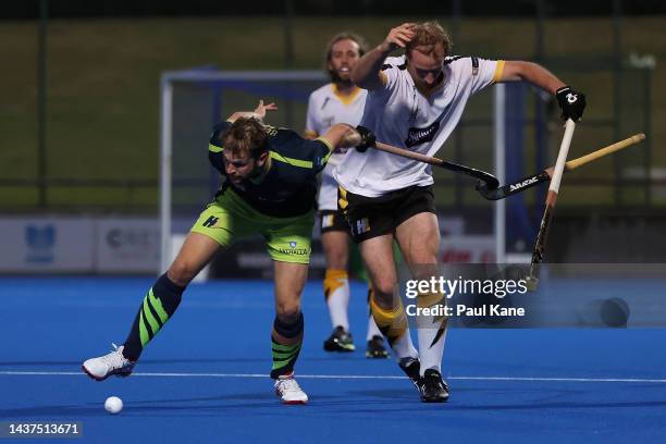 Joshua Beltz of the Tigers and Aran Zalewski of the Thundersticks contest for the ball during the round five Hockey One League match between Perth...