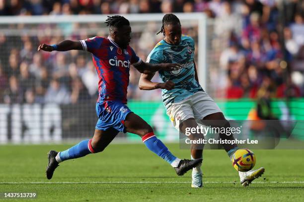 Joe Aribo of Southampton is challenged by Jeffrey Schlupp of Crystal Palace during the Premier League match between Crystal Palace and Southampton FC...