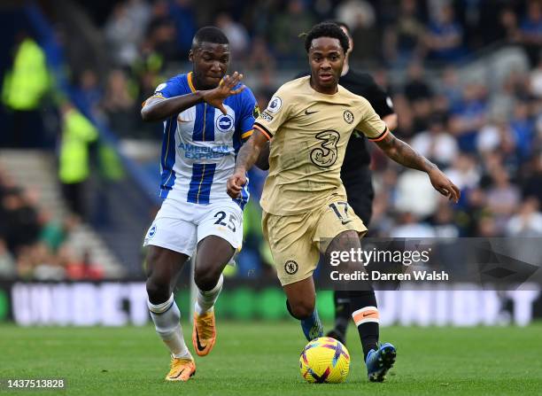 Raheem Sterling of Chelsea is challenged by Moises Caicedo of Brighton & Hove Albion during the Premier League match between Brighton & Hove Albion...