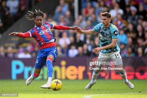 Michael Olise of Crystal Palace is challenged by Romain Perraud of Southampton during the Premier League match between Crystal Palace and Southampton...