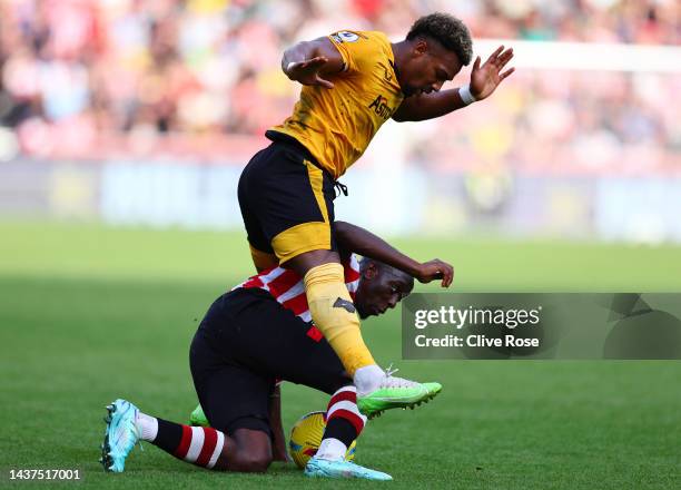 Adama Traore of Wolverhampton Wanderers challenges Yoane Wissa of Brentford during the Premier League match between Brentford FC and Wolverhampton...