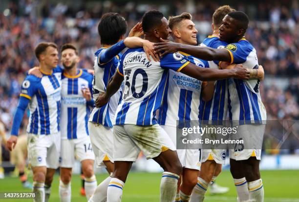 Pervis Estupinan of Brighton & Hove Albion celebrates with teammates after their sides third goal after an own goal by Trevoh Chalobah of Chelsea...