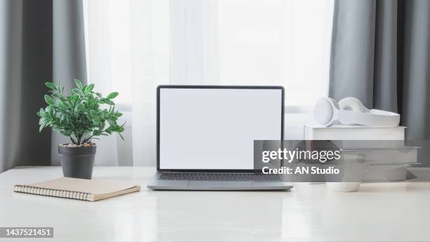 workplace with laptop computer on table at home. laptop with blank screen on white table. home interior or office background - notepad white table foto e immagini stock