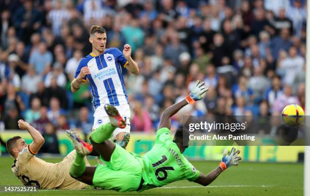 Pascal Gross of Brighton & Hove Albion scores their team's fourth goal past Edouard Mendy of Chelsea during the Premier League match between Brighton...