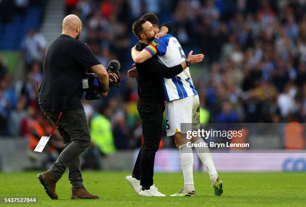 Roberto De Zerbi embraces Lewis Dunk of Brighton & Hove Albion after their sides victory during the Premier League match between Brighton & Hove...