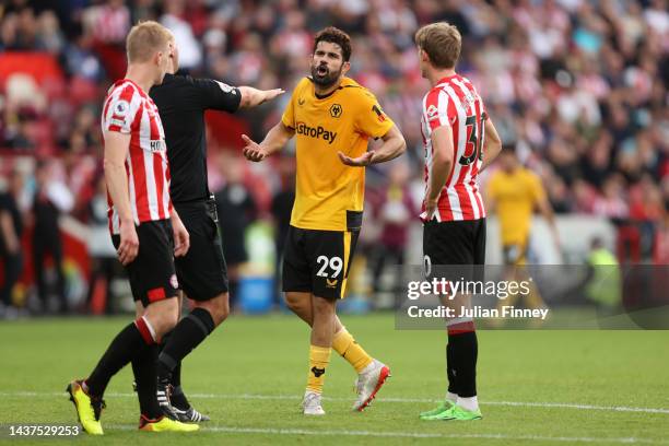 Referee Robert Madley speaks with Diego Costa of Wolverhampton Wanderers during the Premier League match between Brentford FC and Wolverhampton...