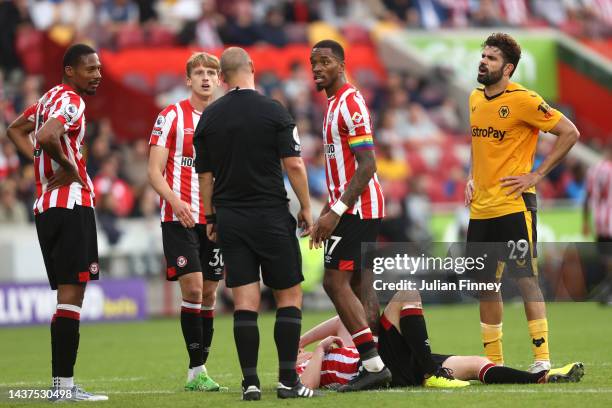 Referee Robert Madley speaks with Diego Costa of Wolverhampton Wanderers, before Diego Costa receives a red card following a VAR Review, during the...