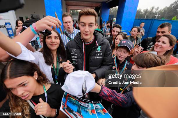 George Russell of Great Britain and Mercedes signs autographs for fans prior to final practice ahead of the F1 Grand Prix of Mexico at Autodromo...